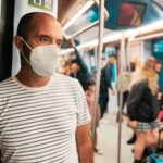 Man with ffp2 face mask traveling by metro, underground, subway, public transportation