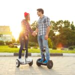 Young couple riding hoverboard