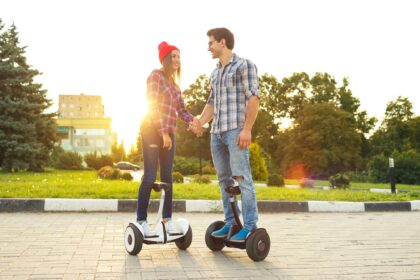 Young couple riding hoverboard
